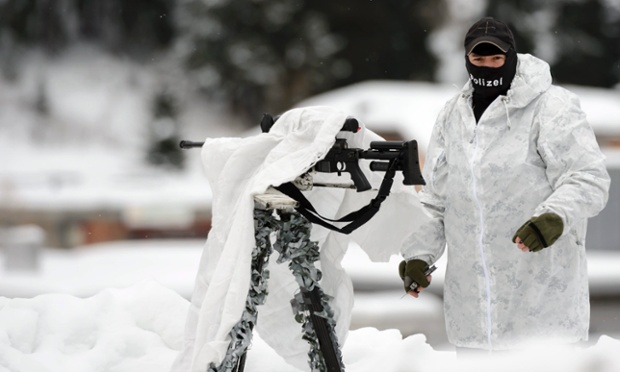 A special forces policeman cover his rifle on the roof of the Congress Centre on the eve of the Annual Meeting of the World Economic Forum, in Davos, Switzerland.