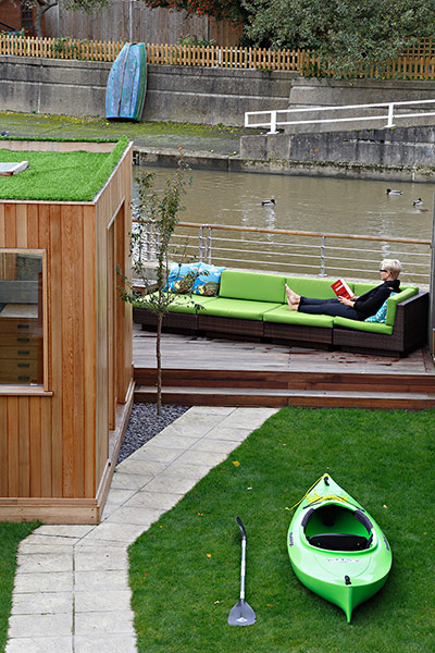 Homes - Petra Tyler: garden with decked area and green sofa