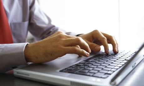 Man's hands on keyboard of laptop computer