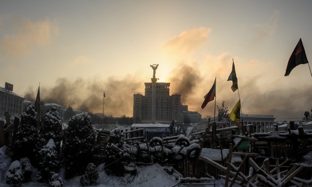 The sunrise above a barricade around of the anti-government protesters' camp on Independence Square. The violent protests have been raging in the Ukrainian capital since 19 January.
