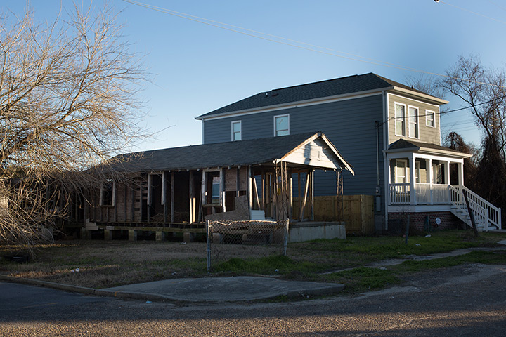 Rebuilding New Orleans: Skeleton of a shotgun house next to a brand new, two-storey home on Delery 