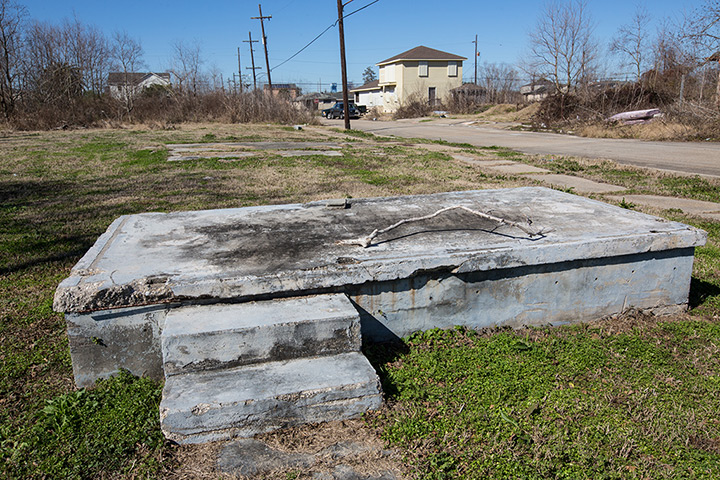 Rebuilding New Orleans: Foundation of a home left in the path of a broken levee in from of a new ho