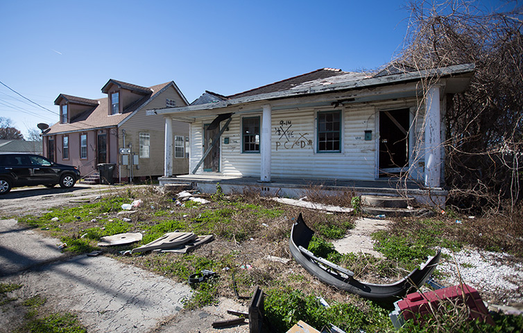 Rebuilding New Orleans: An abandoned house bearing an 