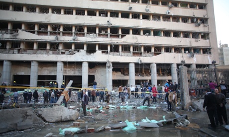 Emergency workers gather at the Egyptian police headquarters after the blast in central Cairo