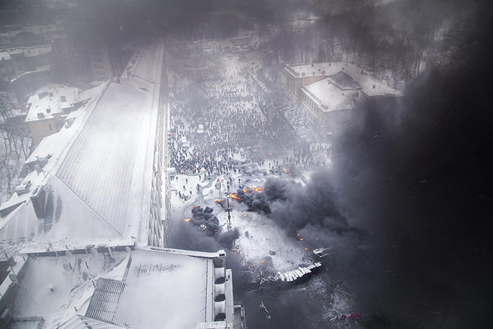 20 Photos: An aerial view shows pro-European protesters burning tyres in Kiev