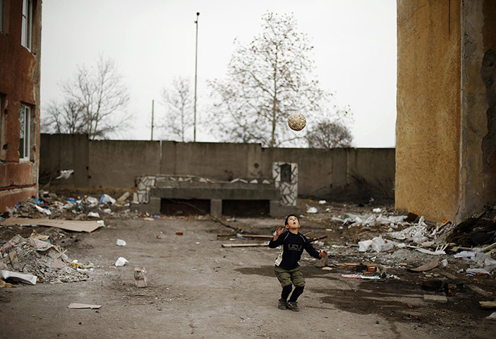 20 Photos: A Syrian refugee boy plays with a ball in Harmanli, Bulgaria