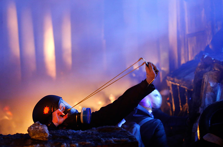 Protests in Ukraine: A protester uses a catapult to launch a projectile at the police in Kiev