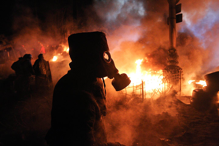 Protests in Ukraine: An anti-government protesters wears a gas mask at the barricades in Kiev