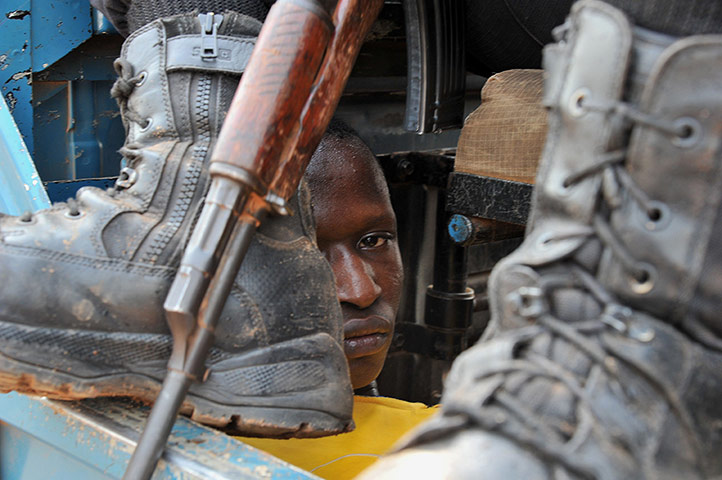 20 Photos: A policeman guards a man arrested after looting in Bangui
