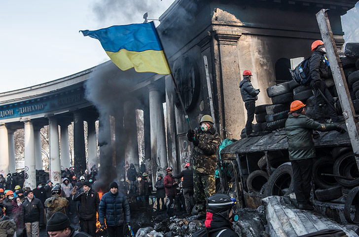 Ukraine: An anti-government protester waves a Ukrainian 