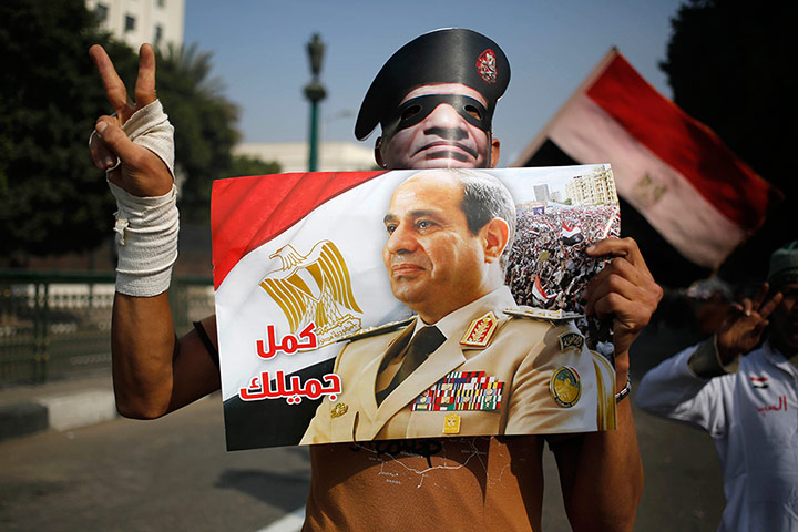 Cairo protest: a poster and a mask depicting Gen. Abdel-Fattah el-Sissi