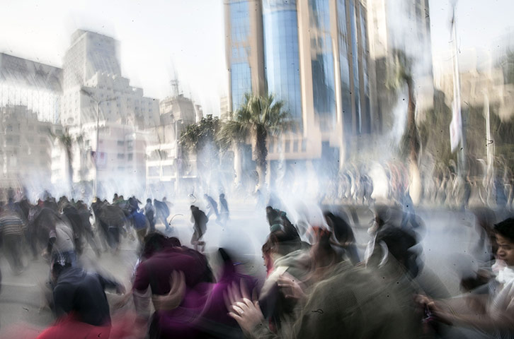 Cairo protest: Anti-government protesters run for cover