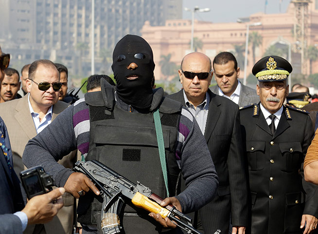 Cairo protest: A policeman guards Cairo's state security chief, Osama al-Saghi
