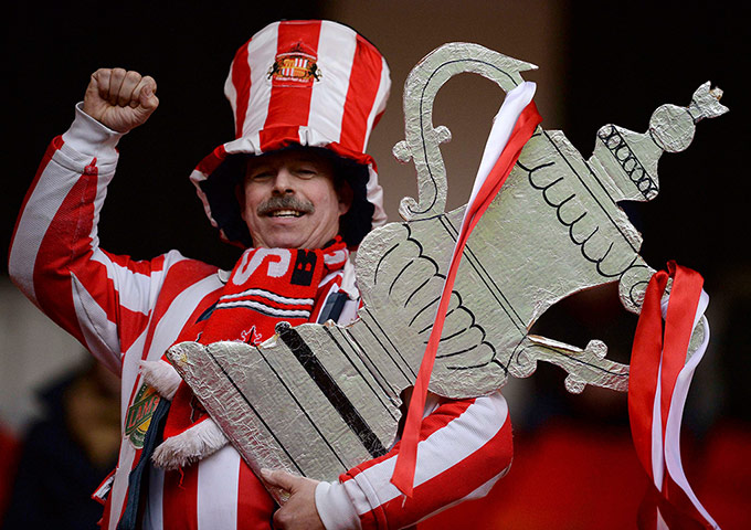 Saturday's games: Sunderland fan holds a foil cup 