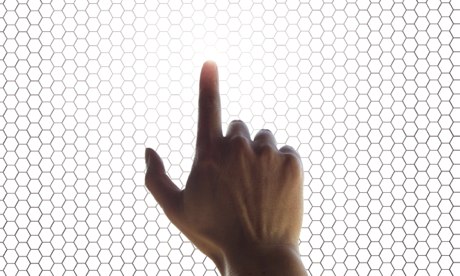 hand on a touchscreen grid