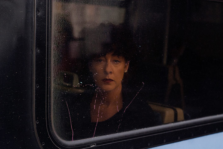 Big Picture - Commuters: woman looking out of train window
