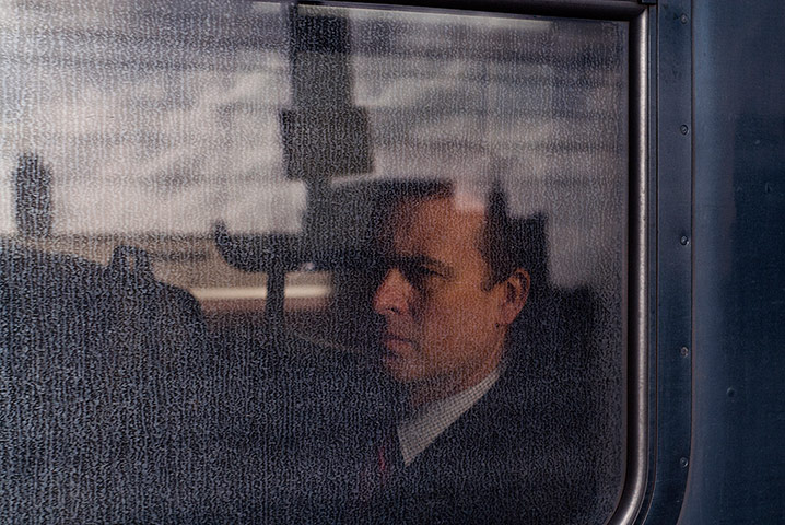 Big Picture - Commuters: Man looking out from train window