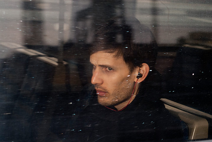 Big Picture - Commuters: young man with headphones looking out from train window