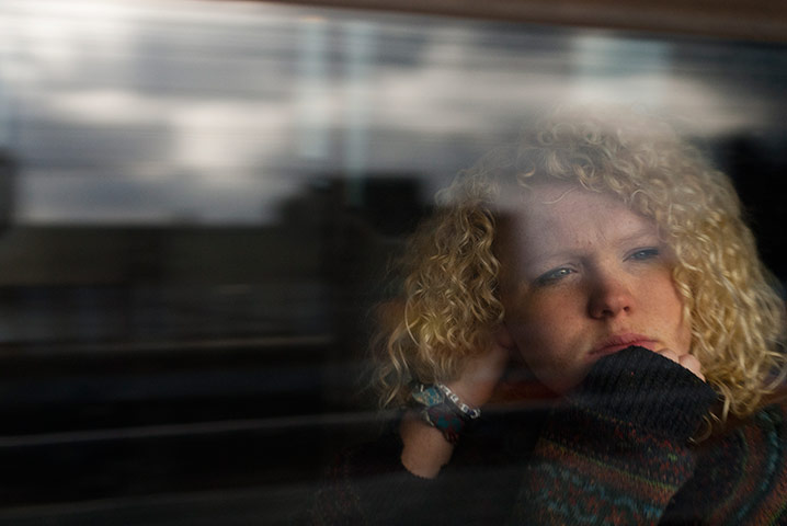 Big Picture - Commuters: girl with blond hair looking out from train window