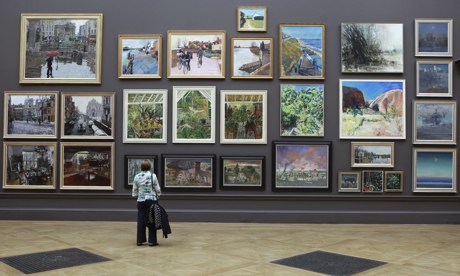 Woman looking at paintings