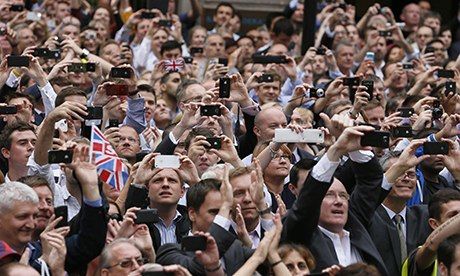 Spectators take pictures with their smartphones