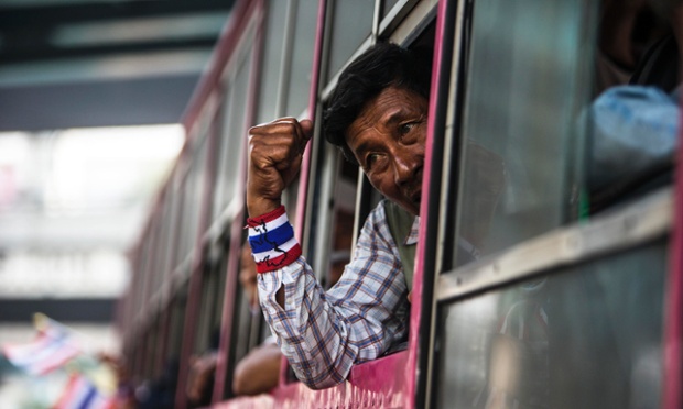 An anti-government protester gestures out of a bus window during a rally in Nonthaburi province, Thailand.