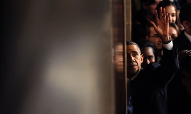 President Barack Obama waves as he walks through a door to leave the House chamber after giving his State of the Union address on Capitol Hill in Washington.