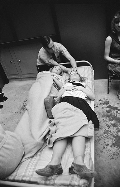 Beatles in America: Beatles fans are attended to by a paramedic