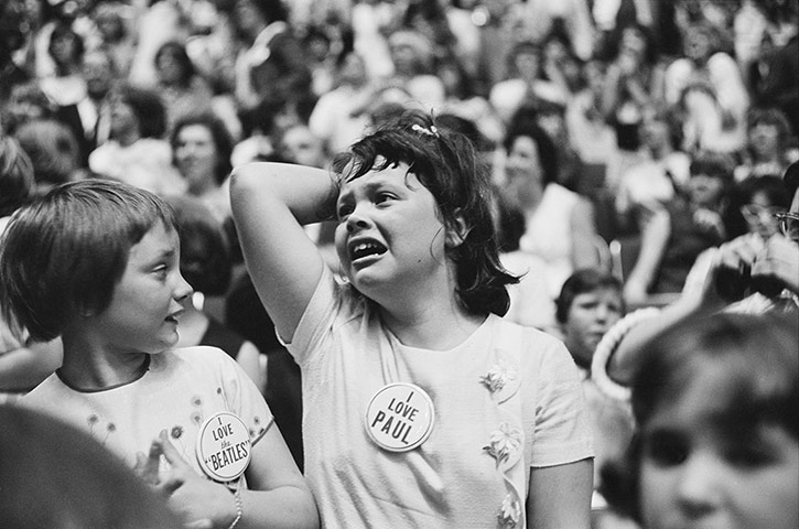Beatles in America: a fan in the crowd watches The Beatles perform at the Seattle Centre Colise