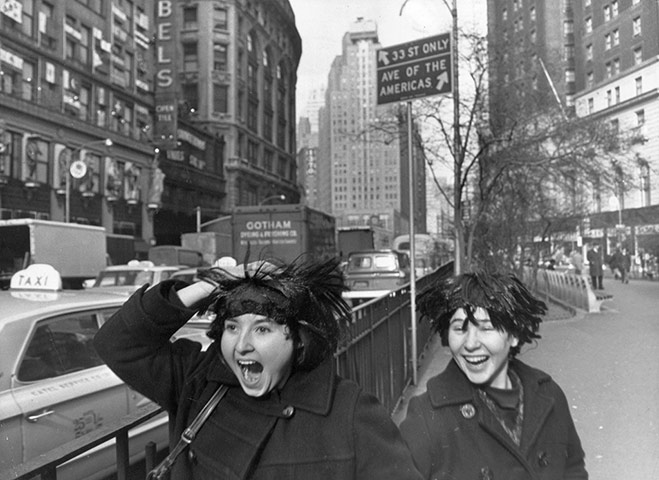 Beatles in America: Two fans try out their Beatles wigs in anticipation of the group's arrival