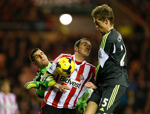 wednesday's matches: Sunderland's goalkeeper Mannone and O'Shea challenge Stoke City's Crouch 