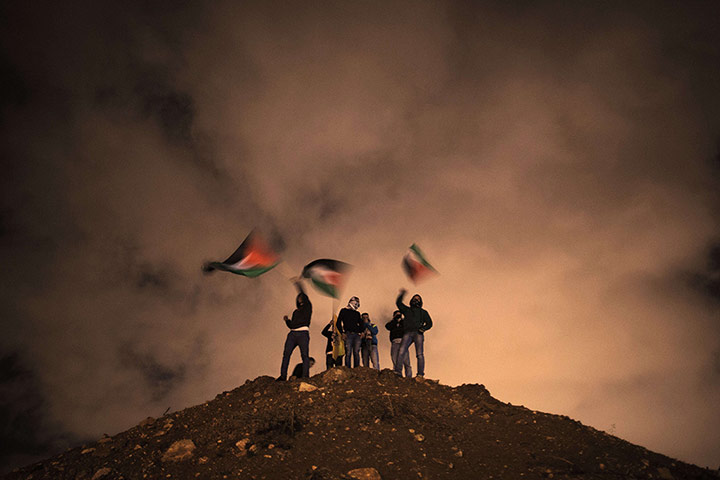 20 Photos: Palestinians wave their national flag before the release of prisoners