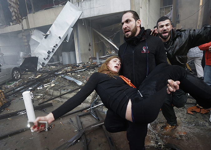 20 Photos: A Lebanese man carries an injured woman in Beirut