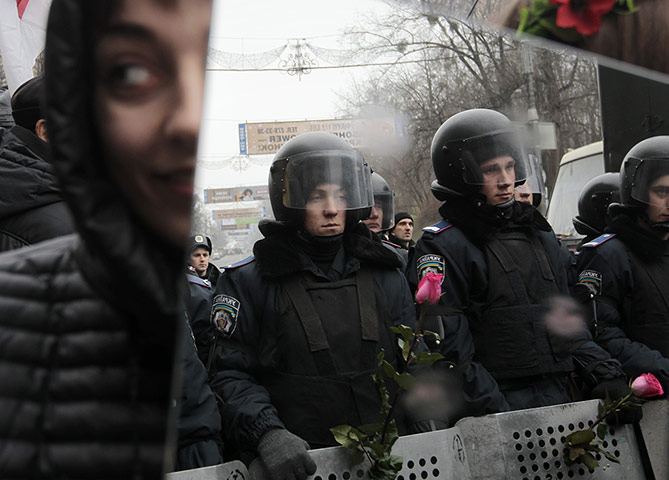 20 Photos: A pro-European demonstrator holds a mirror in Kiev, Ukraine