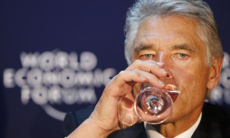 CEO of Nestle Peter Brabeck-Letmathe drinks water during a news conference at the WEF in Davos