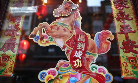 An image of a horse hangs in a restaurant window in China Town, London. 
