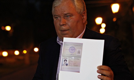 Lawyer Anatoly Kucherena with a picture of Snowden's new refugee documents, August 1, 2013. 