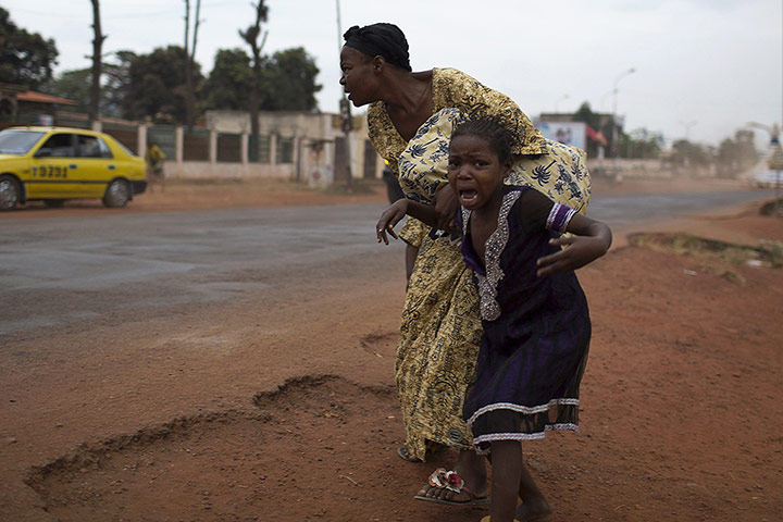 20 Photos: A mother holds her child while attempting to take cover in Bangui