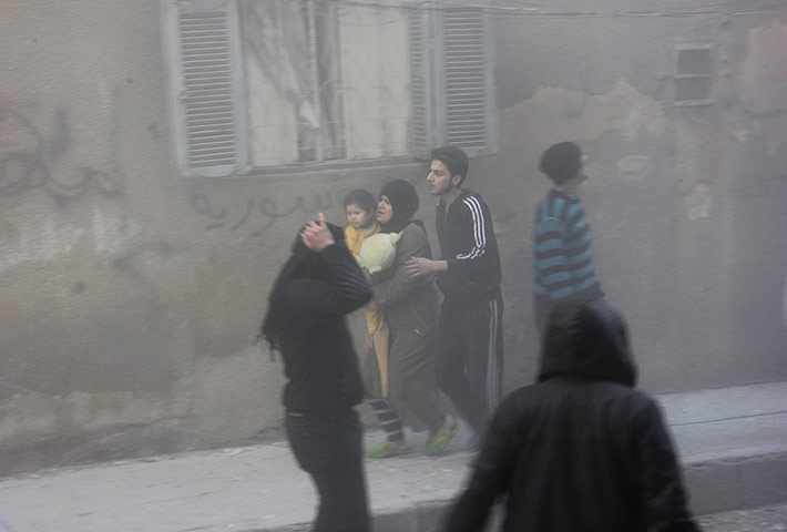 20 Photos: Syrian civilians run following an alleged air strike in Aleppo