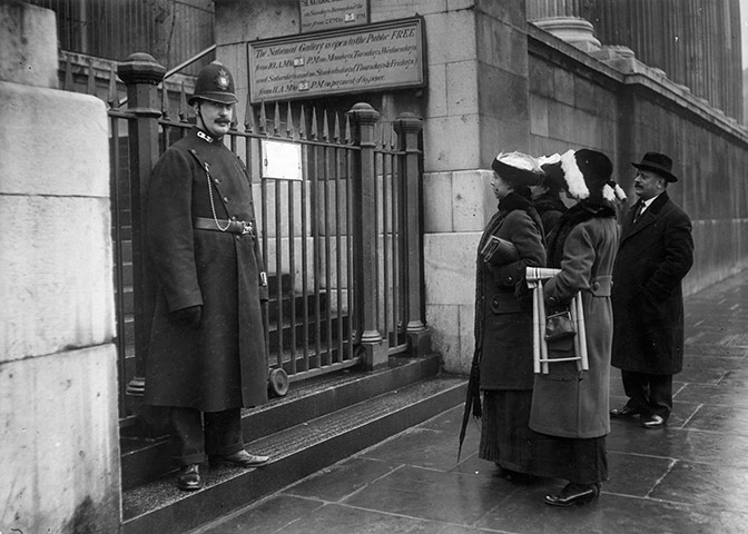 Before the war: Visitors reading a sign outside the National Gallery in 1914