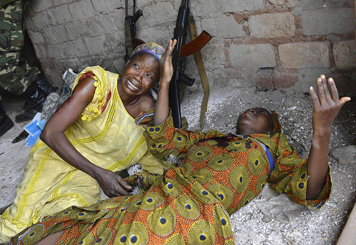 Weekend in pictures: Two wounded women await medical attention after a grenade was thrown at the