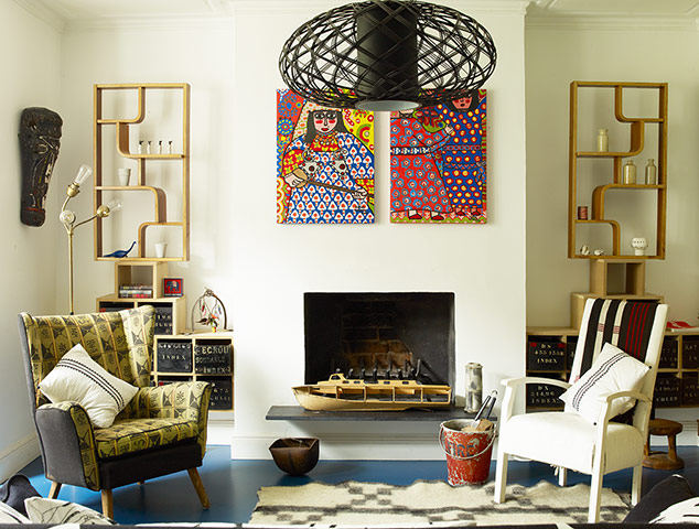 Homes - Hollicks House: Armchairs in living room with open fireplace and shelving units