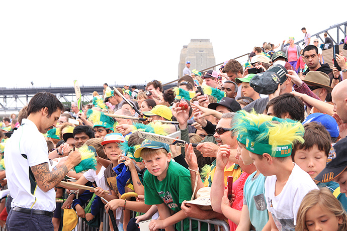 Celebrations: Fans crowd Mitchell Johnson for autographs
