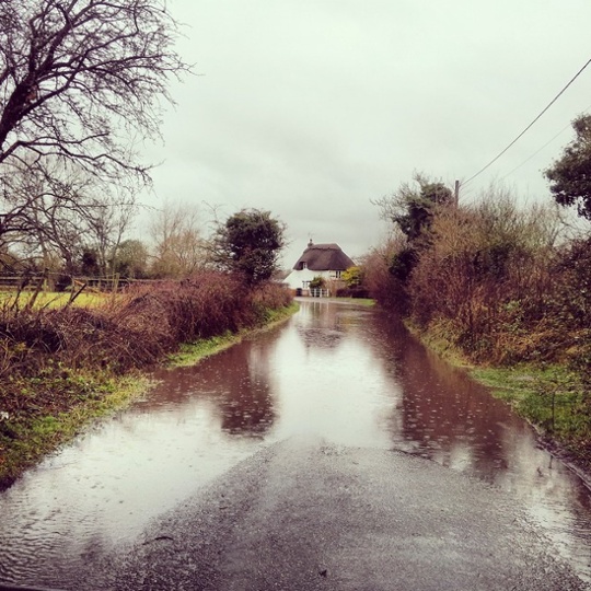 A cottage within sight of the White Horse of Uffington, Dorset gets cut off by a rising brook.