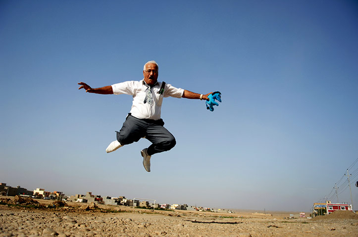 Big Picture - Iraq Flying: Iraqi man jumping with blue sky background