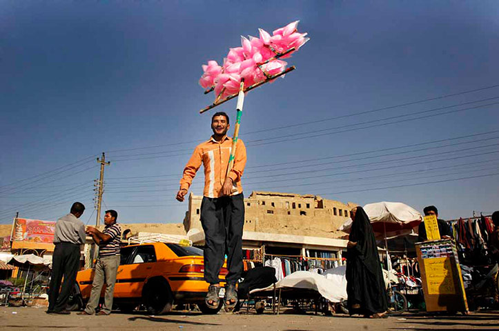 Big Picture - Iraq Flying: Iraqi candy floss seller jumping 