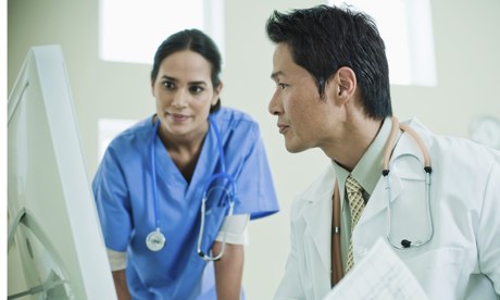 Doctors looking at computer