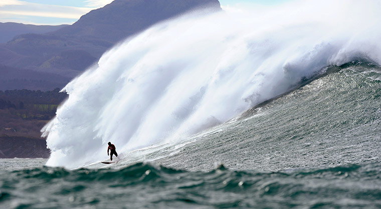 Stormy weather: A man surfs the Belharra giant waves som