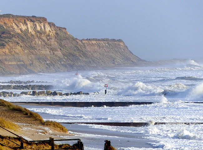 Stormy weather: Stormy weather and high waves at Hengistbury Head, Dorset, Britain