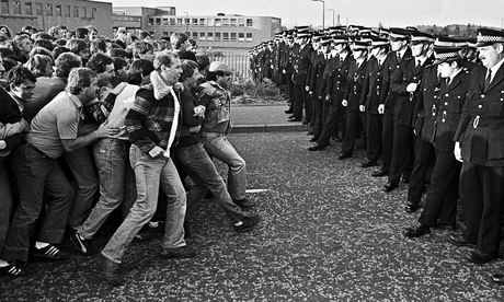 Striking miners facing line of police